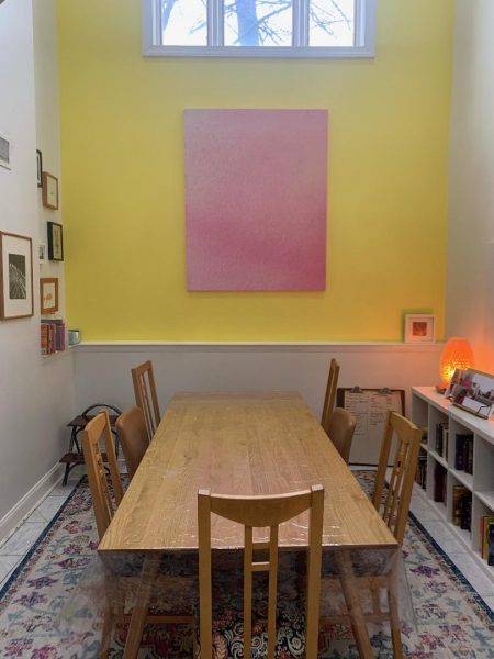 After: Acoustic panel with custom fabric acts as a noise buffer and joyful piece of artwork which captures the family's cheerful style. Area rug with extra-thick padding further reduces noise.