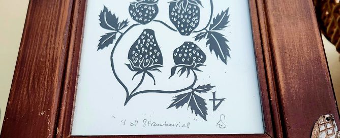 Four fresh strawberries on a clean surface