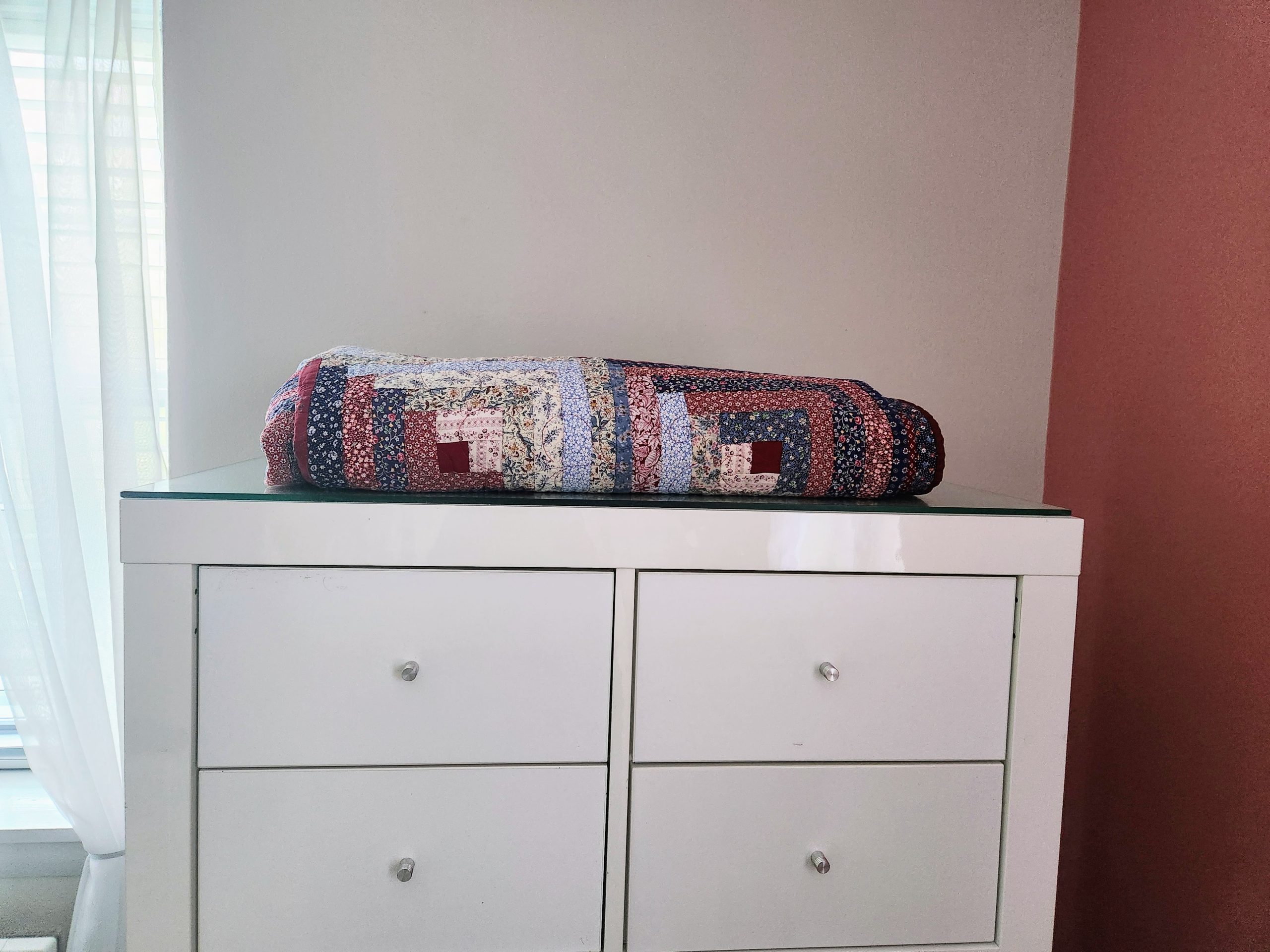 BedroomQuiltColor Colorful quilt on a neatly arranged bedroom bed